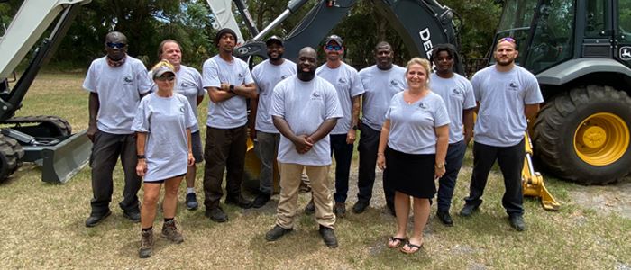 Sanitation Division staff standing in front of heavy equipment