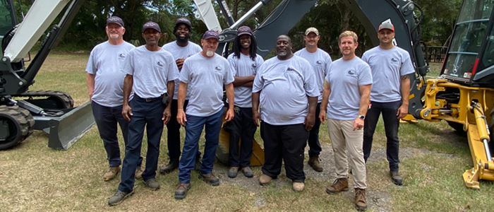 Streets and Stormwater Division Staff outside in front of heavy equipment